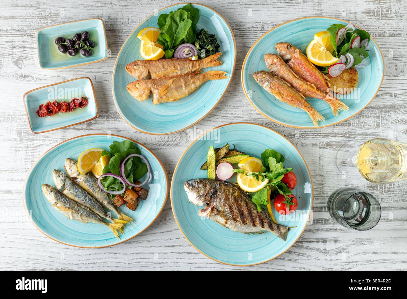 Assorted seafood plates with fish and appetizers on table Stock Photo
