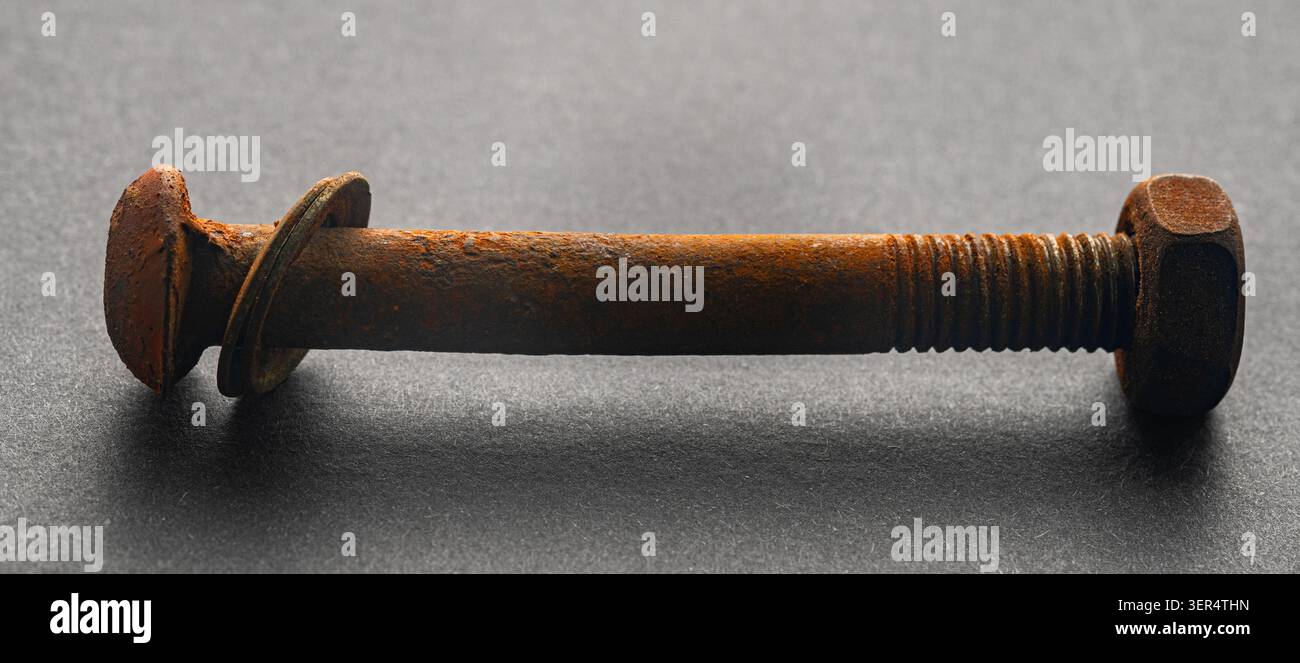rusty construction bolt on a black background Stock Photo