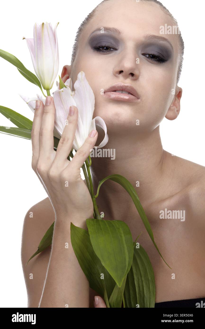 Portrait of beautiful dark haired slavonic model posing with flower Stock Photo