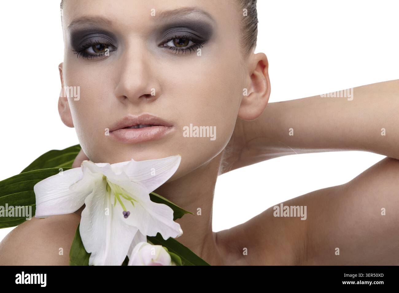 Portrait of beautiful dark haired slavonic model posing with flower Stock Photo