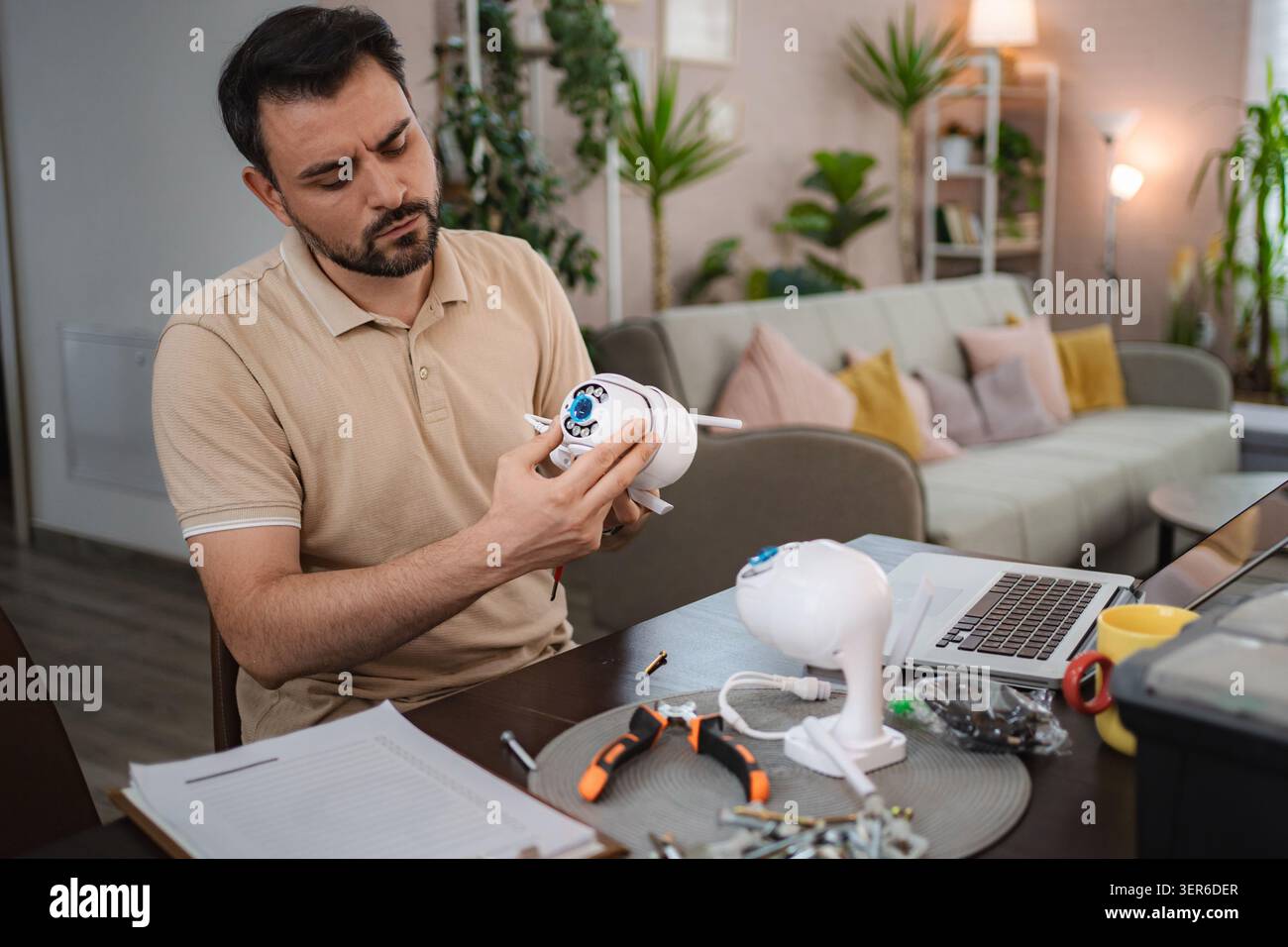 Technician Installing Surveillance Camera at Home Stock Photo