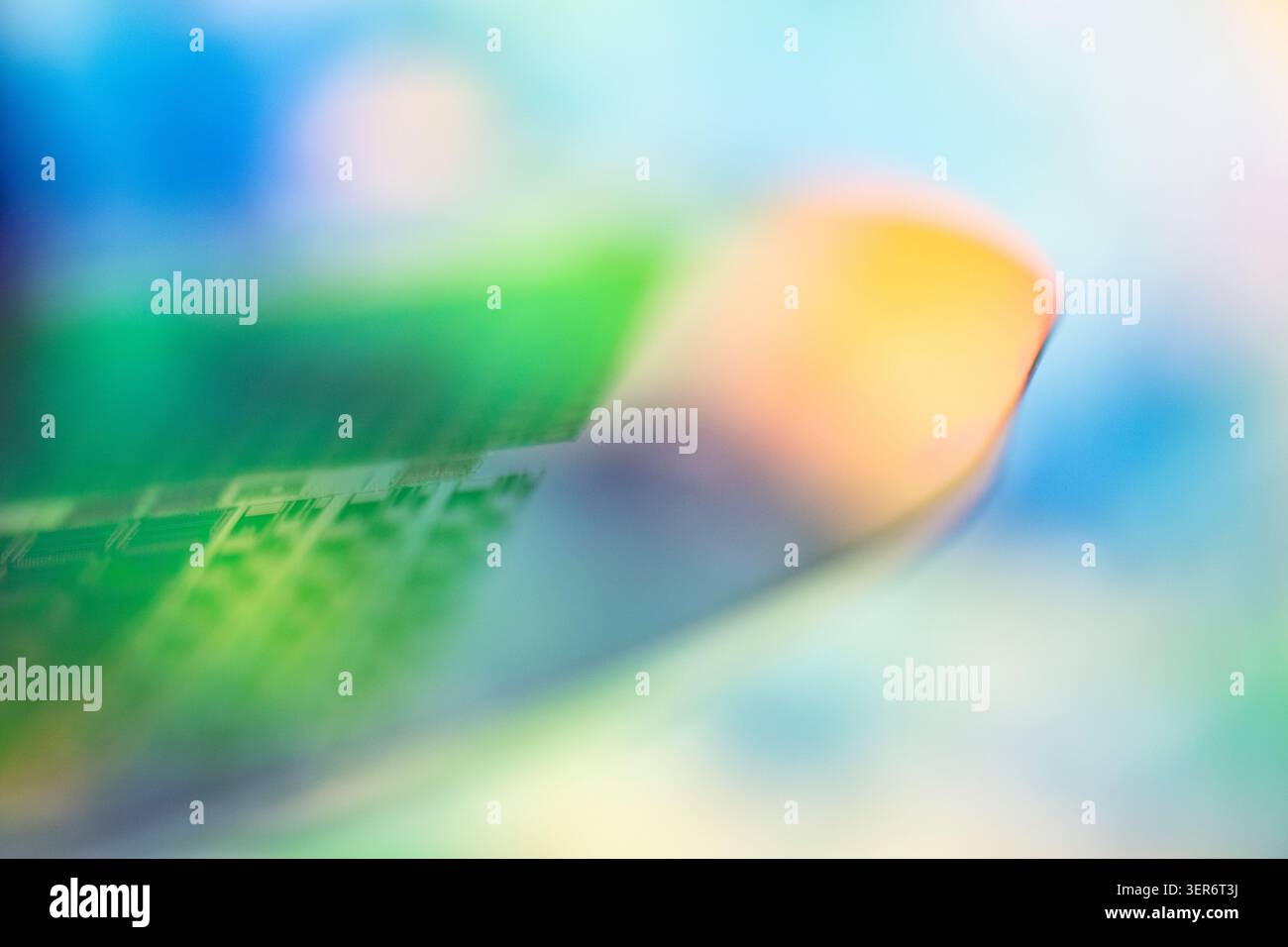 Silicon semiconductor wafer with microchips showing colorful abstract pattern Stock Photo