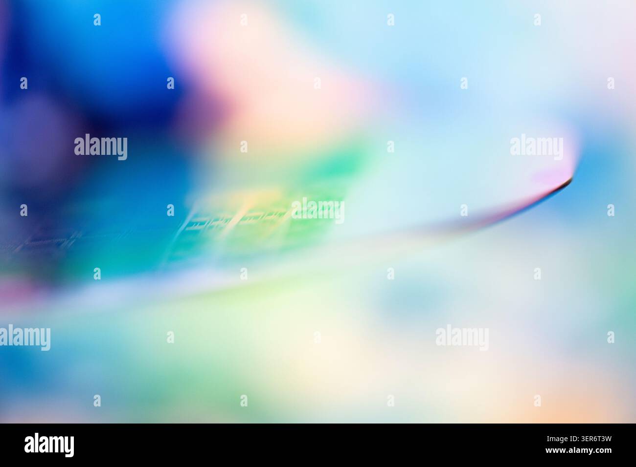 Silicon wafer displaying abstract iridescent colors and semiconductor chip patterns Stock Photo