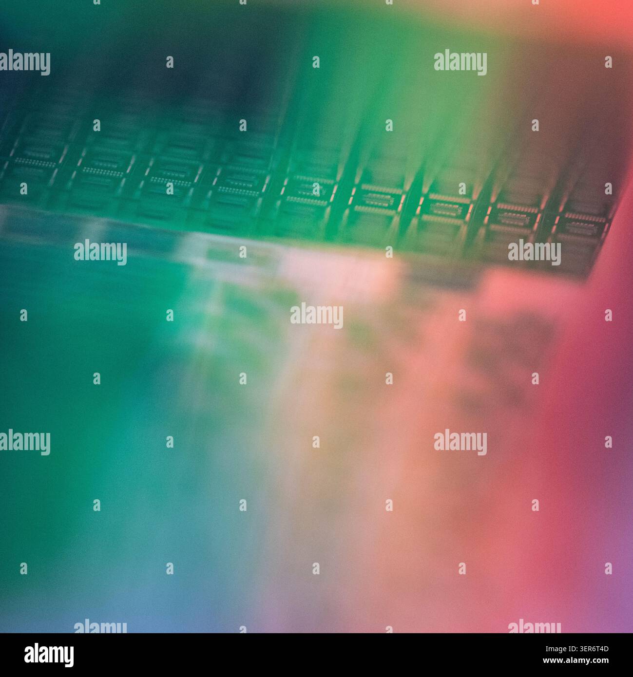 Wafer surface showing electronic chips with colorful reflections Stock Photo