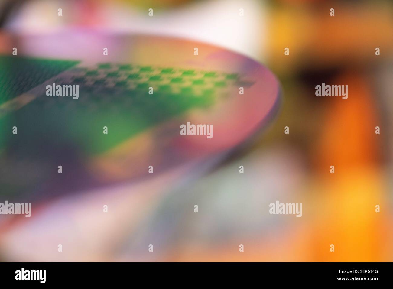 Silicon wafer surface with microchip patterns reflecting vibrant colors and zen bokeh Stock Photo