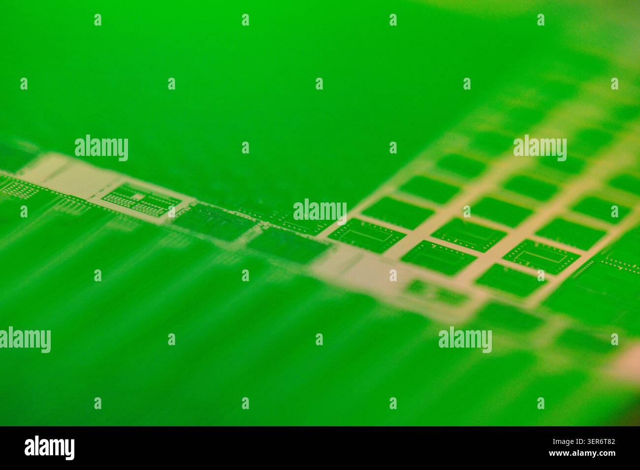 Silicon wafer displaying microchip circuit patterns for modern technology Stock Photo