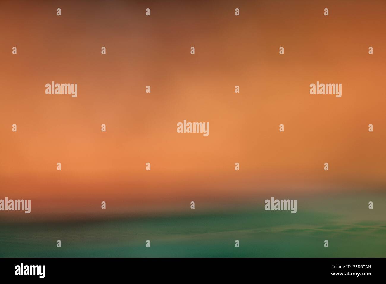Abstract image showing a soft color gradient with orange and turquoise representing horizon Stock Photo