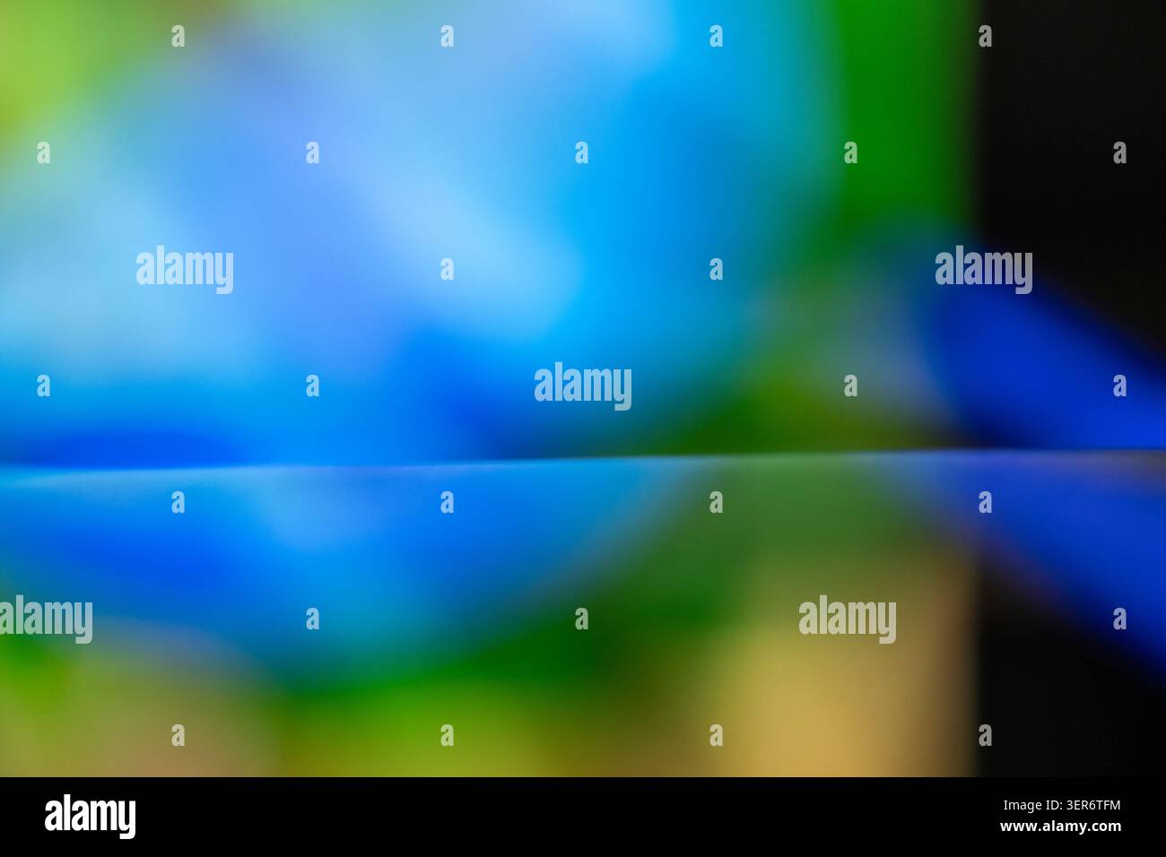 Abstract colorful light creating a blurred blue and green gradient Stock Photo