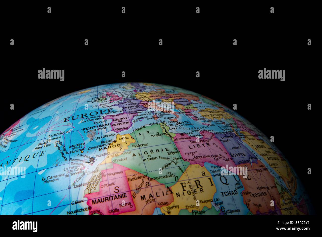 Geographic globe displaying country borders and names for europe and africa on black Stock Photo