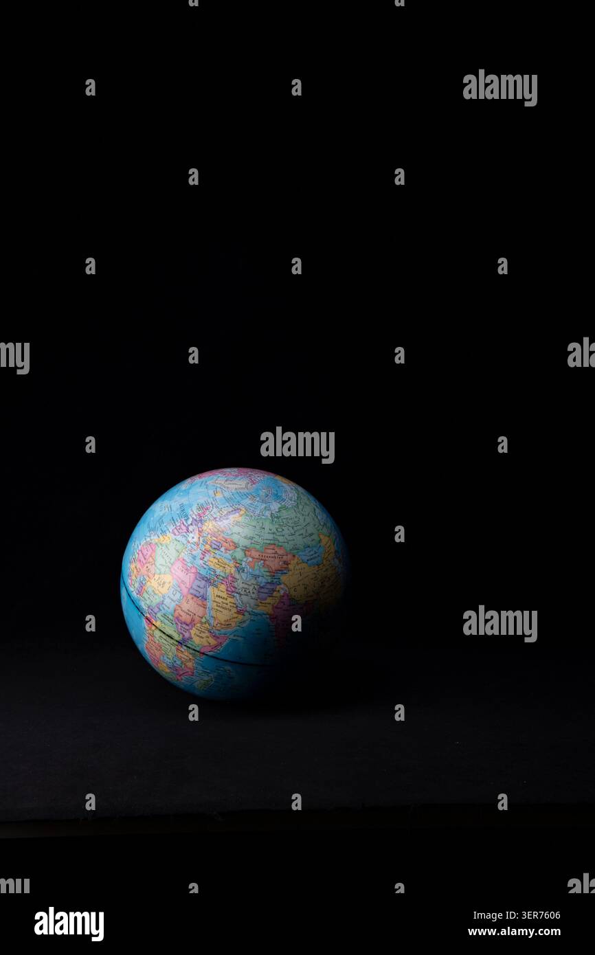 Planet earth model displaying global map on a dark background Stock Photo