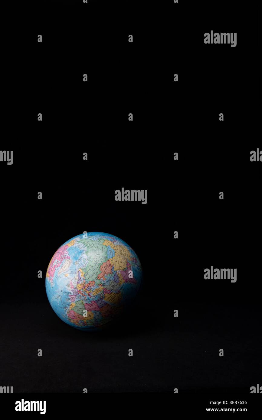 Earth globe highlighting maps and countries on a dark black background Stock Photo