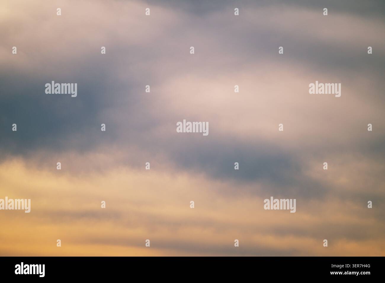 Soft pastel clouds creating a subtle color gradient across the evening sky. Stock Photo