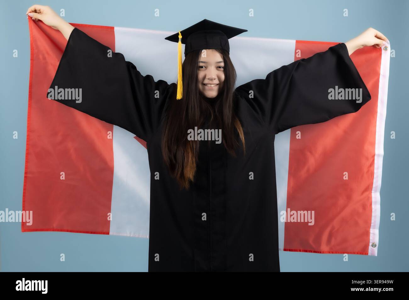 Graduate holding a Canadian flag Stock Photo