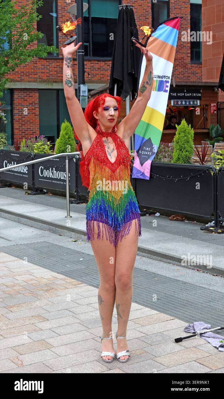 Fire eater in rainbow costume performing at Warrington Pride 2026 in Warrington town centre, Cheshire, England, UK. Stock Photo