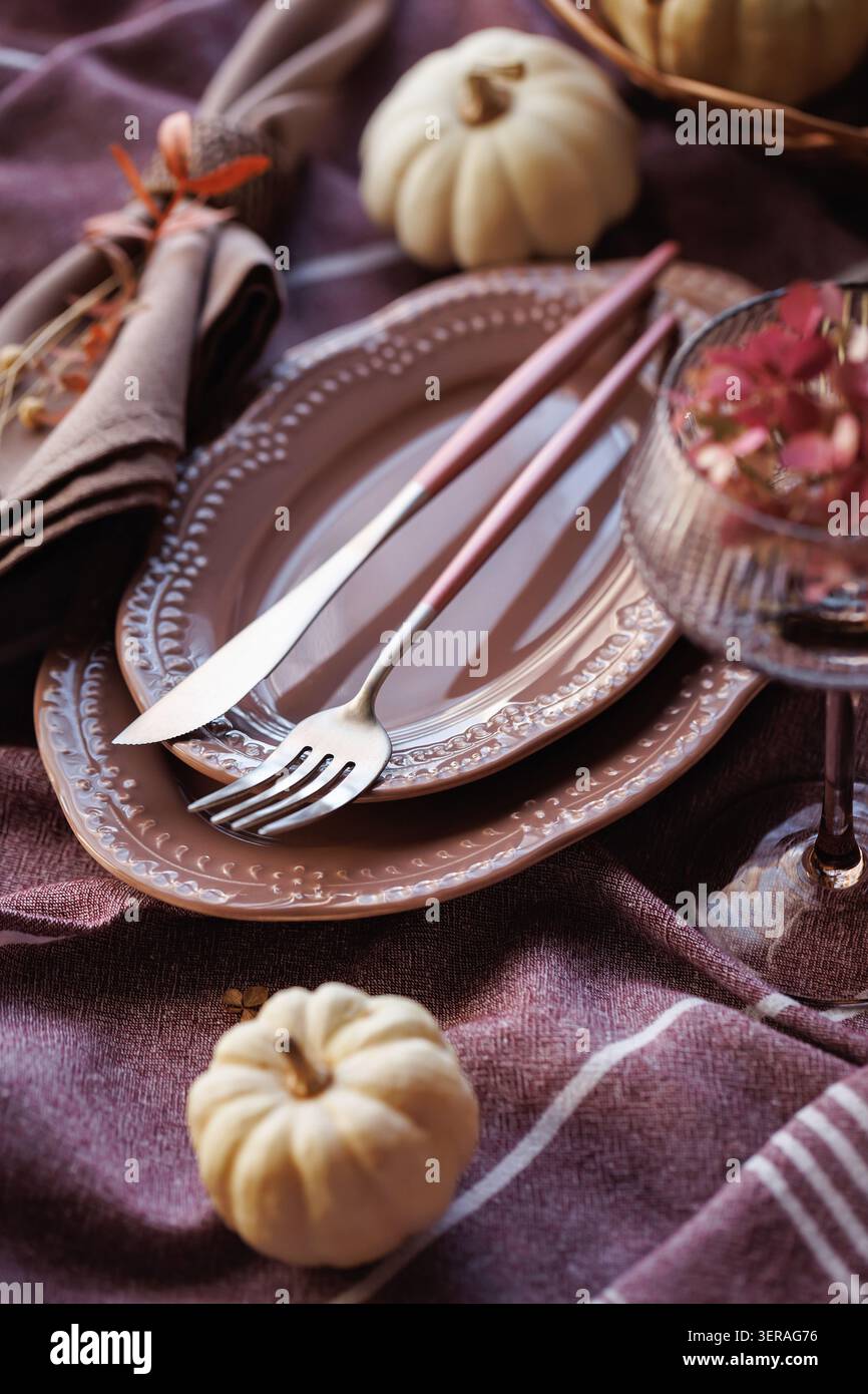 Rustic autumn table setting with pumpkins and elegant tableware Stock Photo