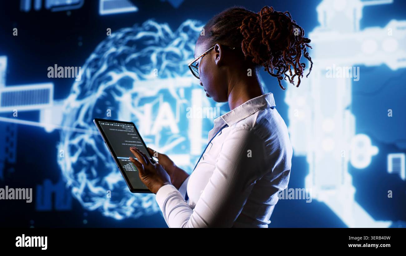 IT specialist updating AI systems, writing intricate binary code scripts on tablet, visualizing result wth AR, Licensed employee using programming to upgrade artificial intelligence simulation model. Stock Photo