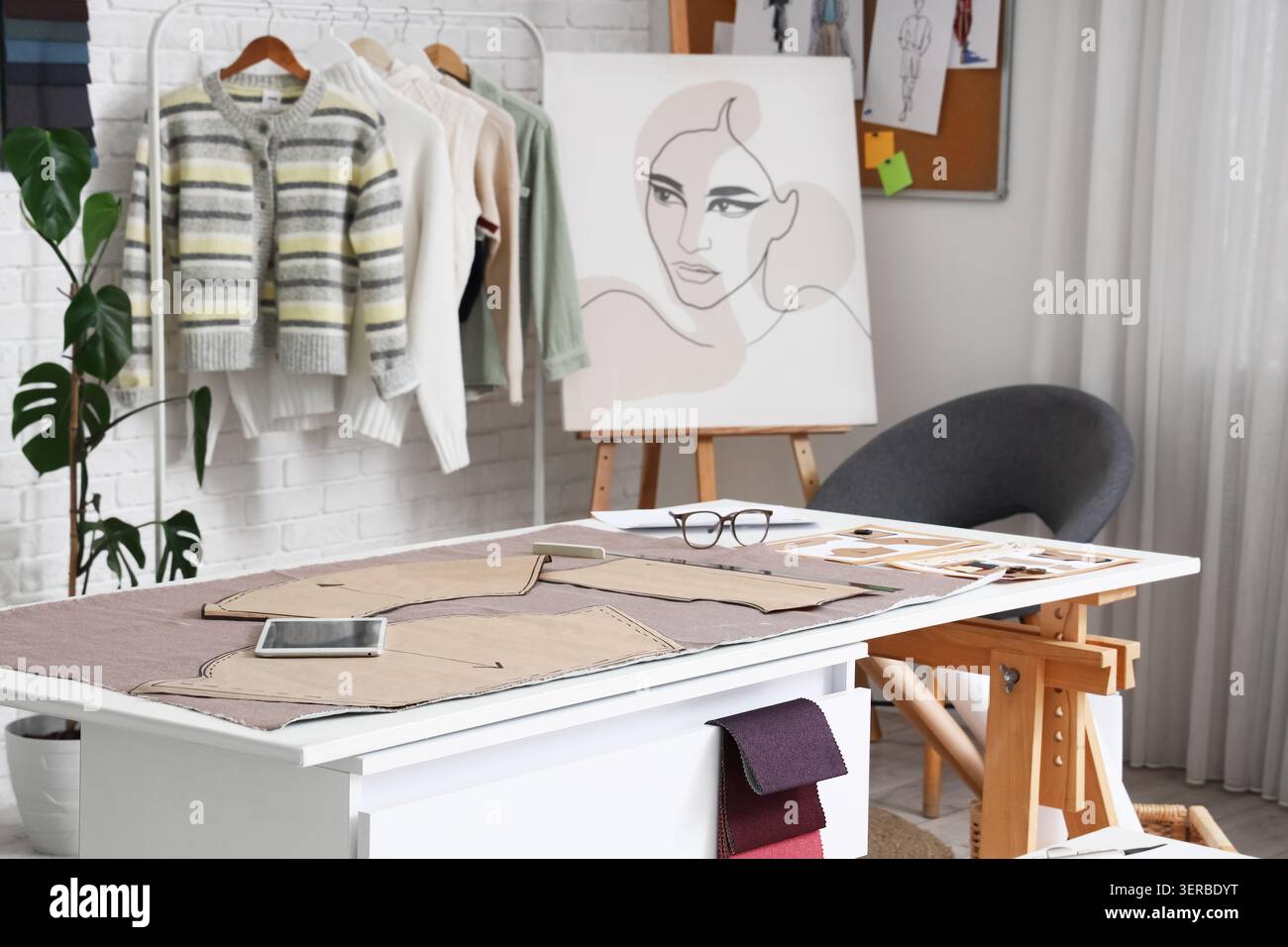 Fabric with patterns on table in fashion designers studio Stock Photo