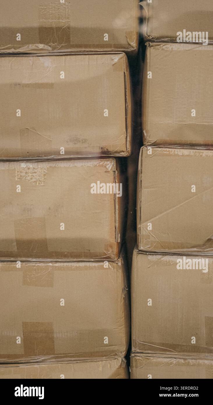 Cardboard boxes stacked in a warehouse closeup. Stock Photo