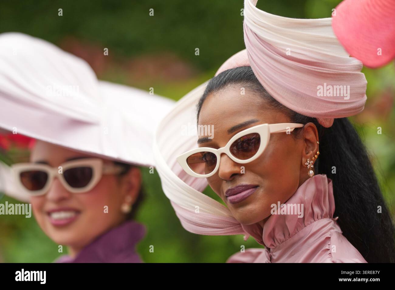 Racegoer Lovely Amusan, right, poses for a picture as she arrives on ...