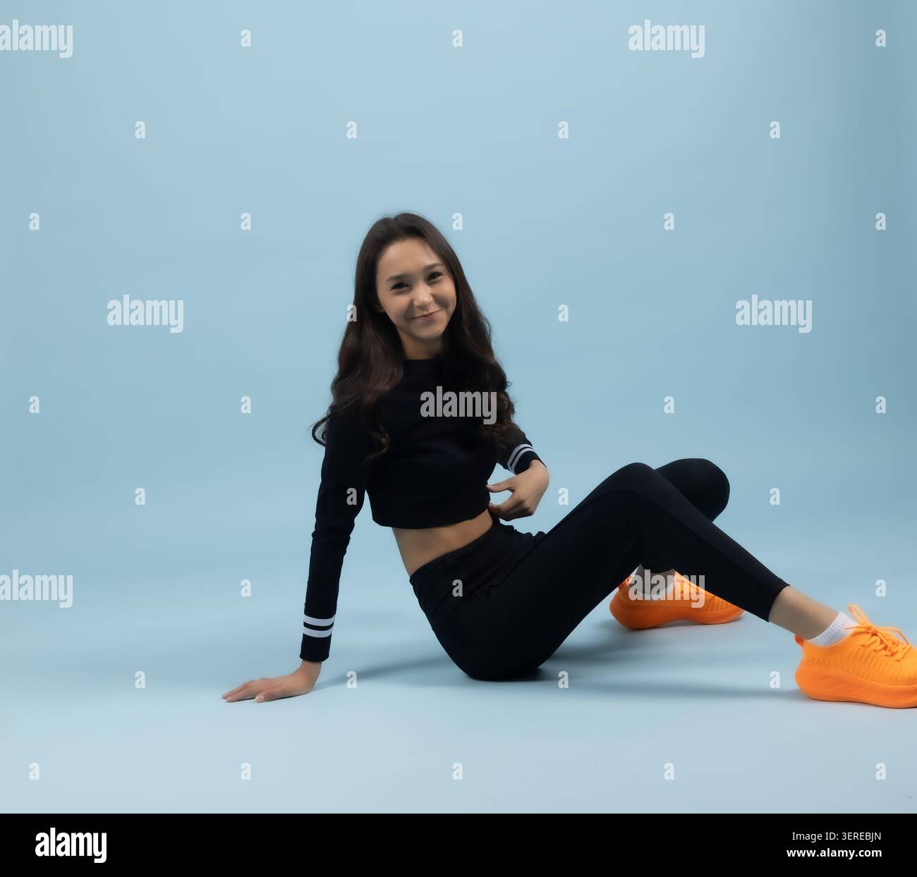 Woman sitting on the floor in a relaxed position Stock Photo - Alamy