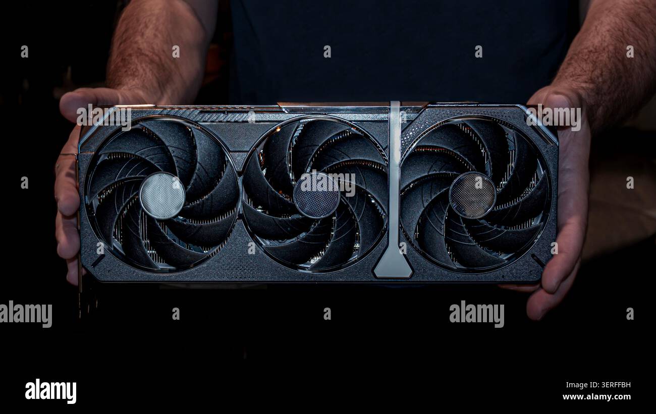 Man Holding Modern Graphics Card for Computer Upgrade Stock Photo