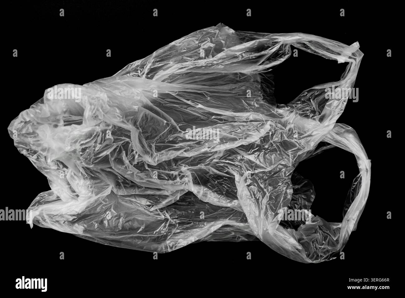 Crumpled Transparent Plastic Shopping Bag on Solid Black Background Stock Photo