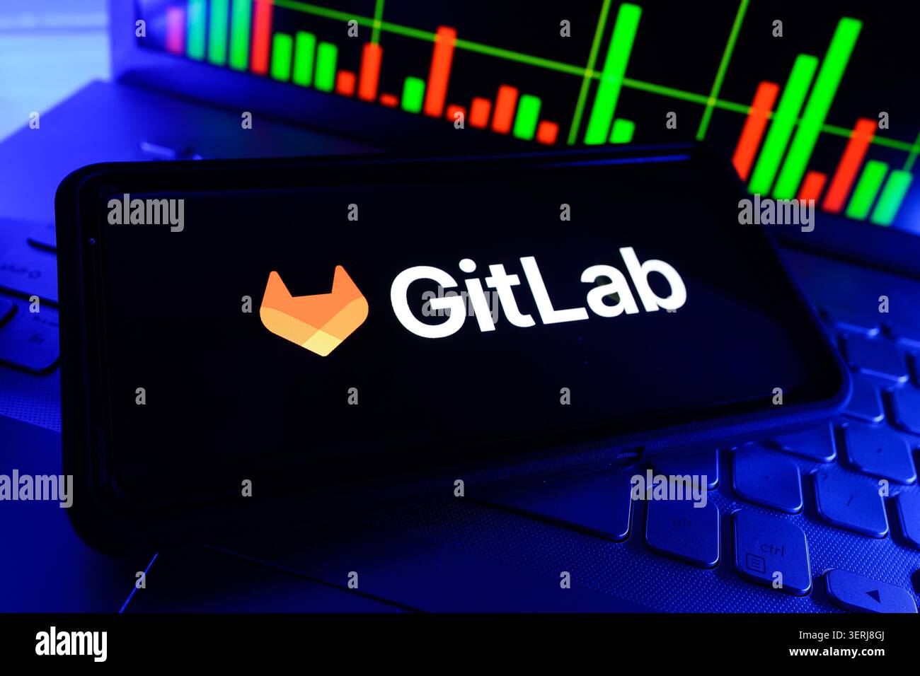 GitLab Inc DevOps Software Development Platform Company Logo Displayed On Mobile Phone Screen With Stock Market Chart Background Stock Photo
