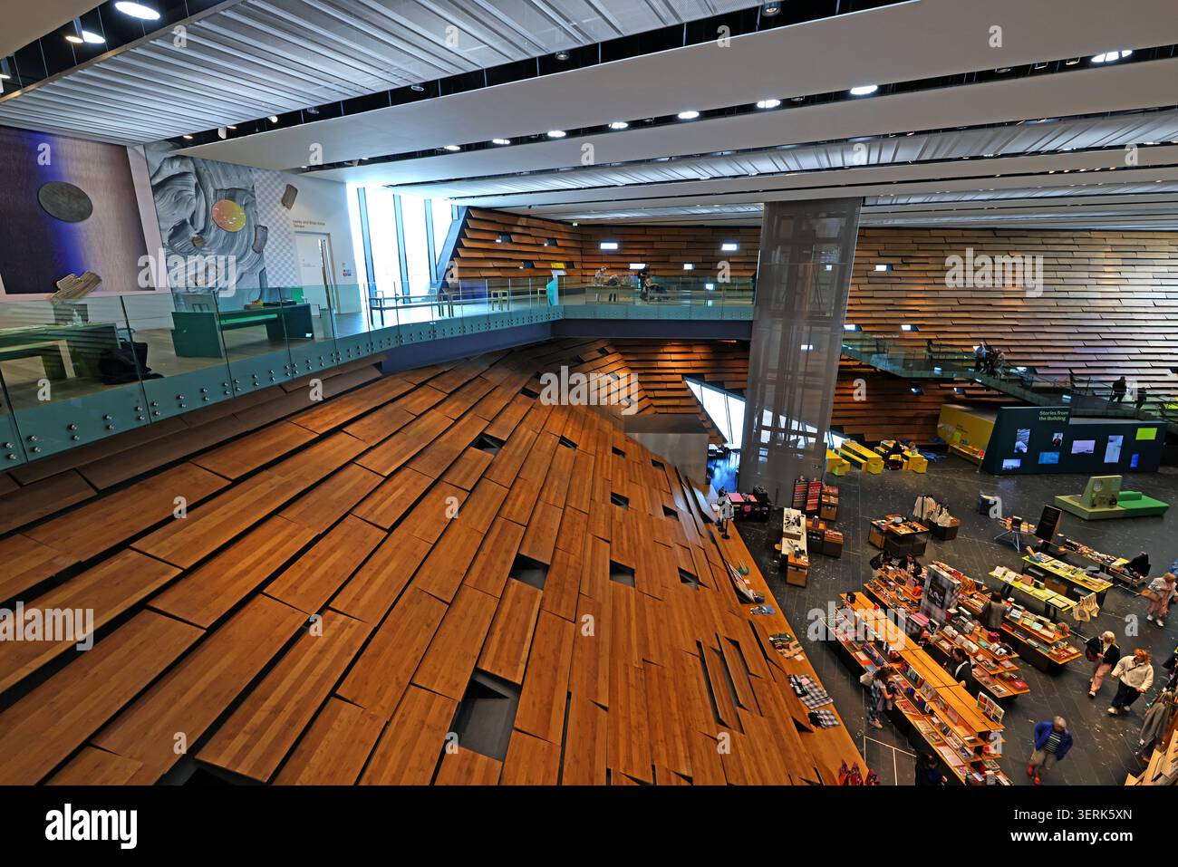 Inside V&A Dundee, with layered wooden walls, glazed balcony and retail displays in the Kengo Kuma-designed waterfront museum. Stock Photo