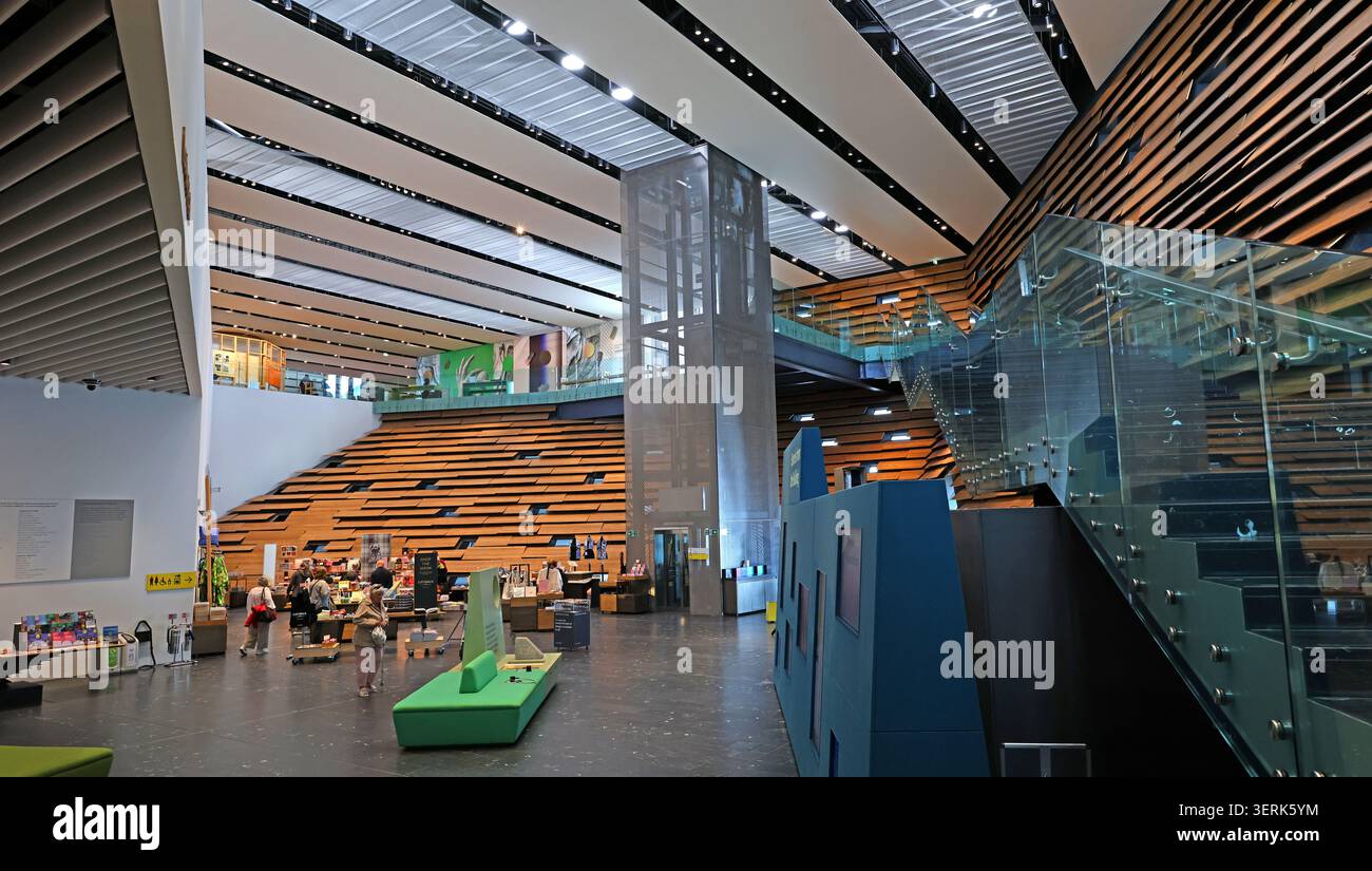 V&A Dundee interior with timber-lined stairs, glass walls and visitors in Dundee, Scotland, UK. Stock Photo