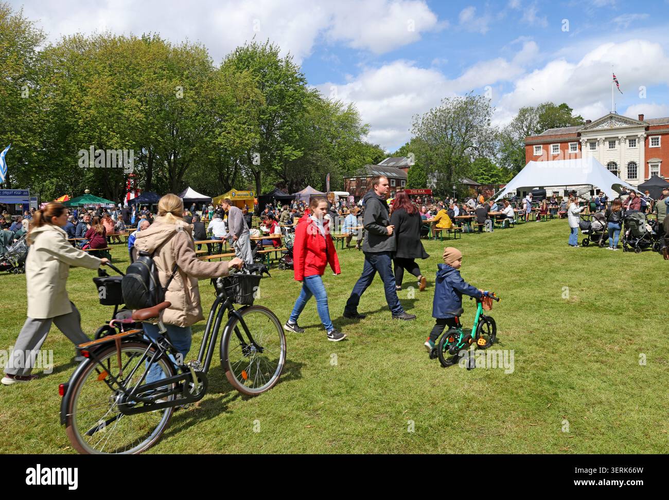 Visitors enjoying a busy outdoor food festival in Warrington, Cheshire, England, UK. Stock Photo