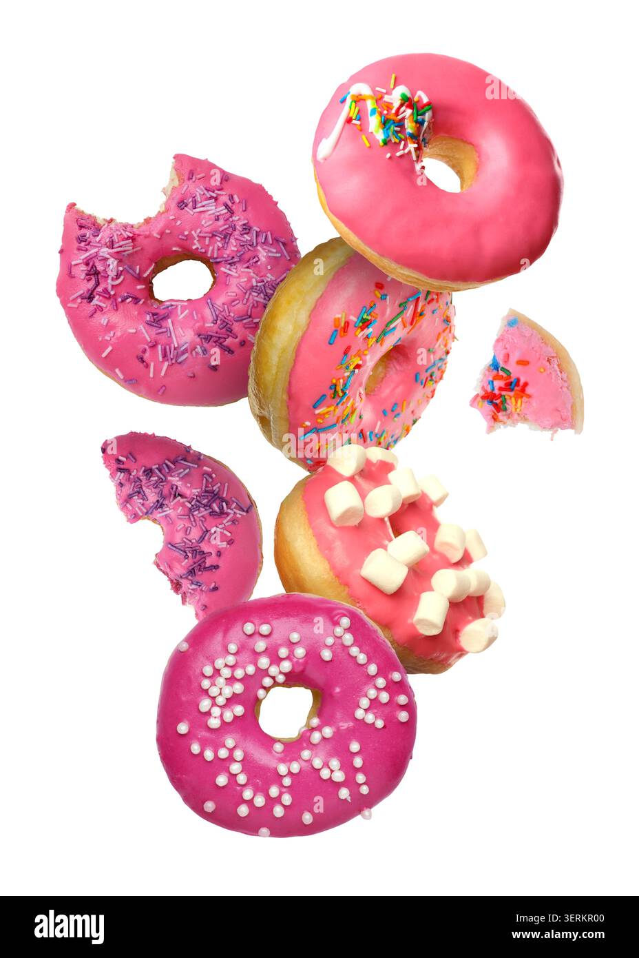 Yummy donuts covered with icing falling on white background Stock Photo