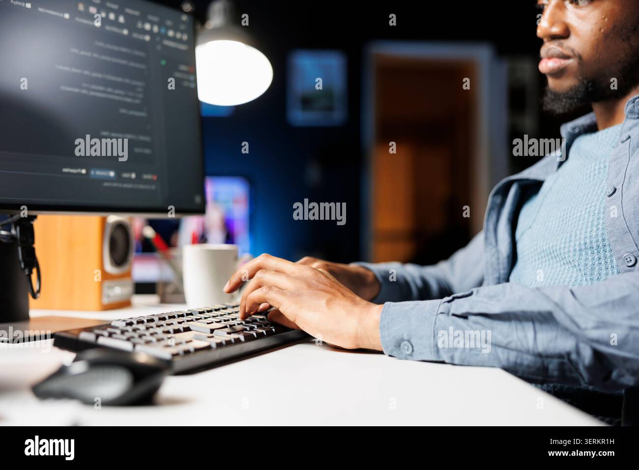 Network administrator functioning via computer programming at home, entering script code for safety and confidentiality; on terminal window, african american technician diagnoses system. Stock Photo