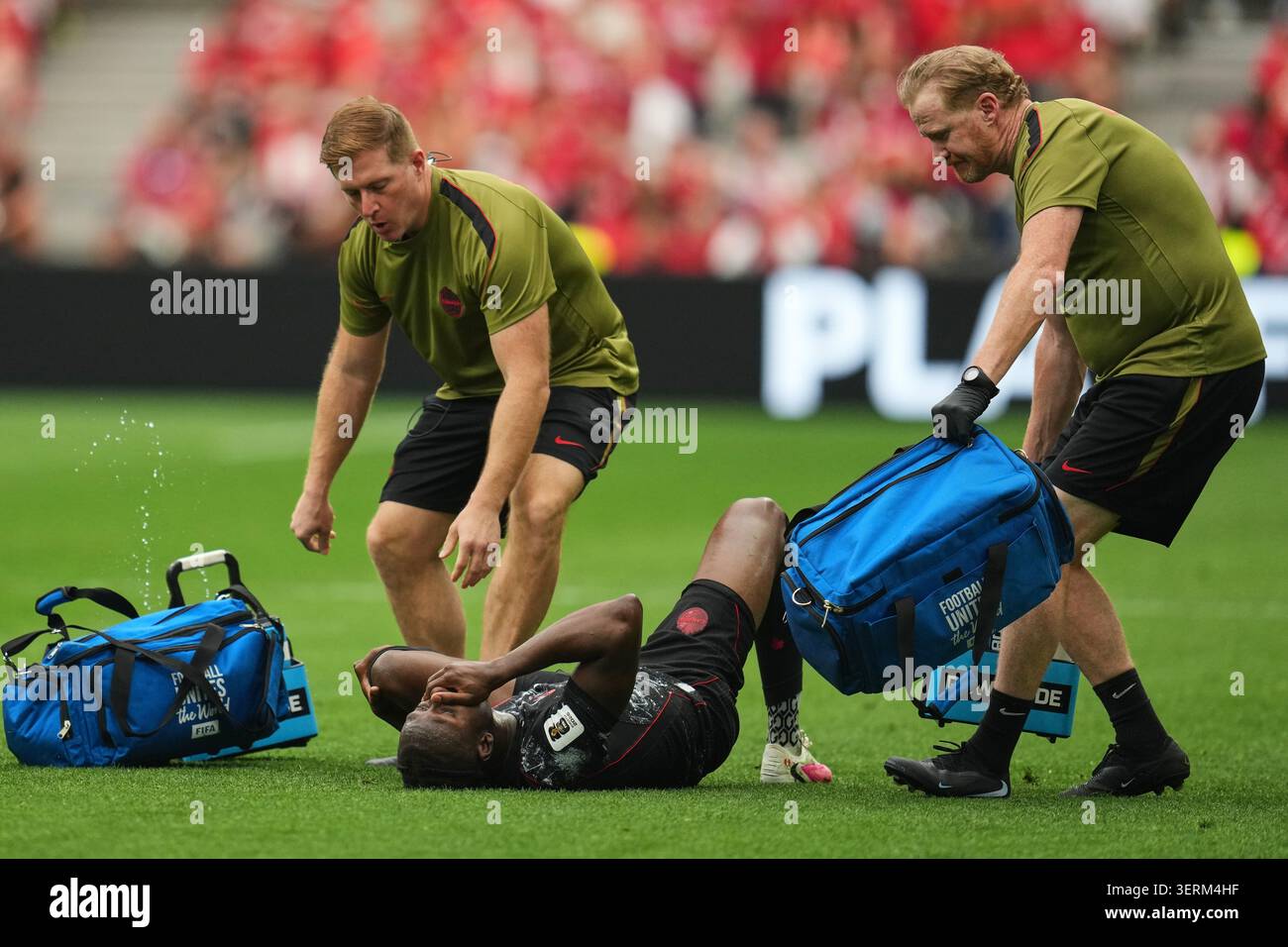 Canada's Ismael Kone, below, recieves medical attention during the ...