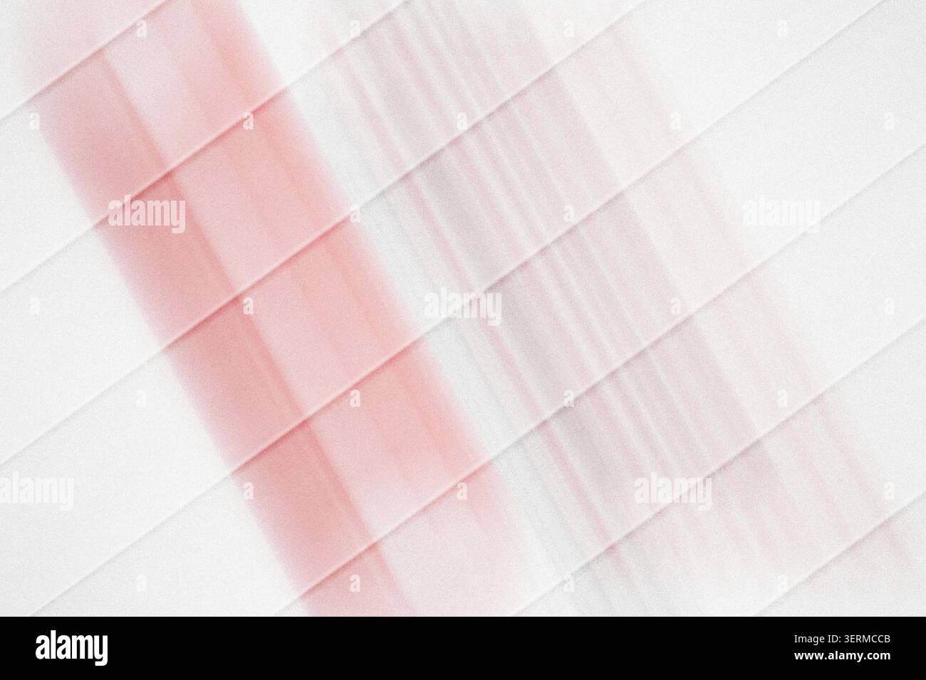 A minimalist abstract composition featuring diagonal stripes intersecting a soft, vertical red light beam, set against a pure white background. Stock Photo