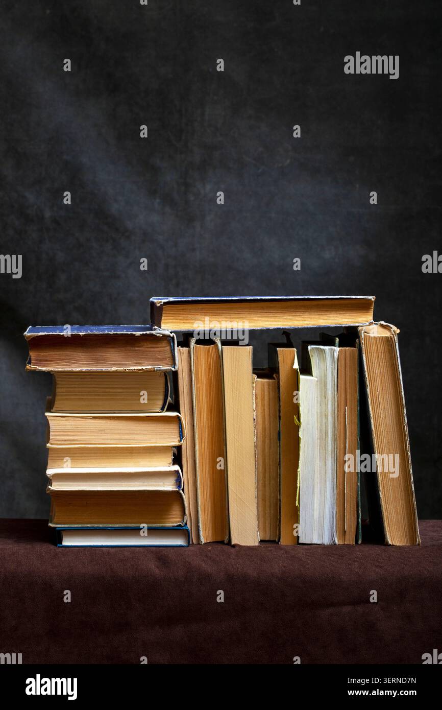 A stack of old books and notebooks on the table Stock Photo