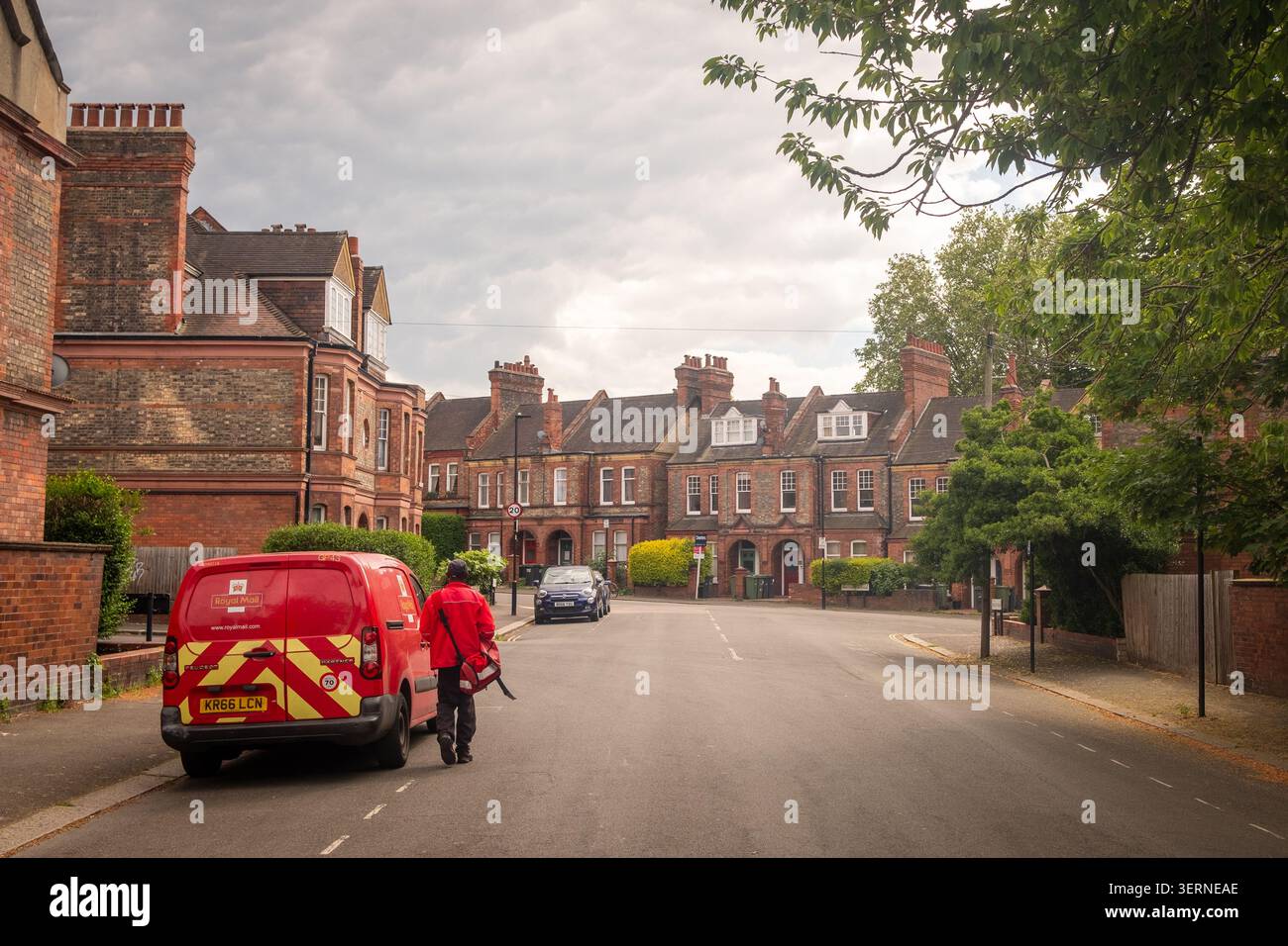 LONDON - MAY 07, 2026: Royal Mail Postman – Postman delivering mail on a quiet Victorian residential street in Streatham Hill. Stock Photo