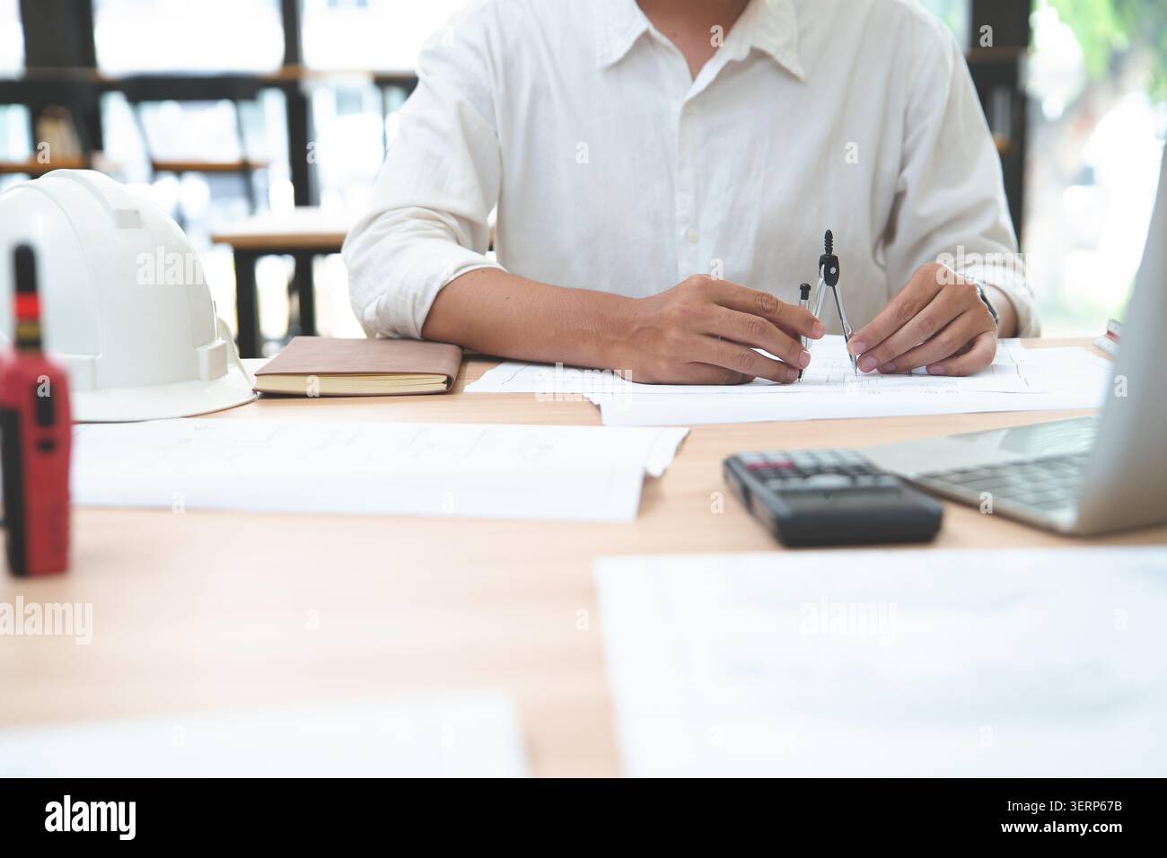 Engineer working with drafting tools and calculator on architect Stock Photo