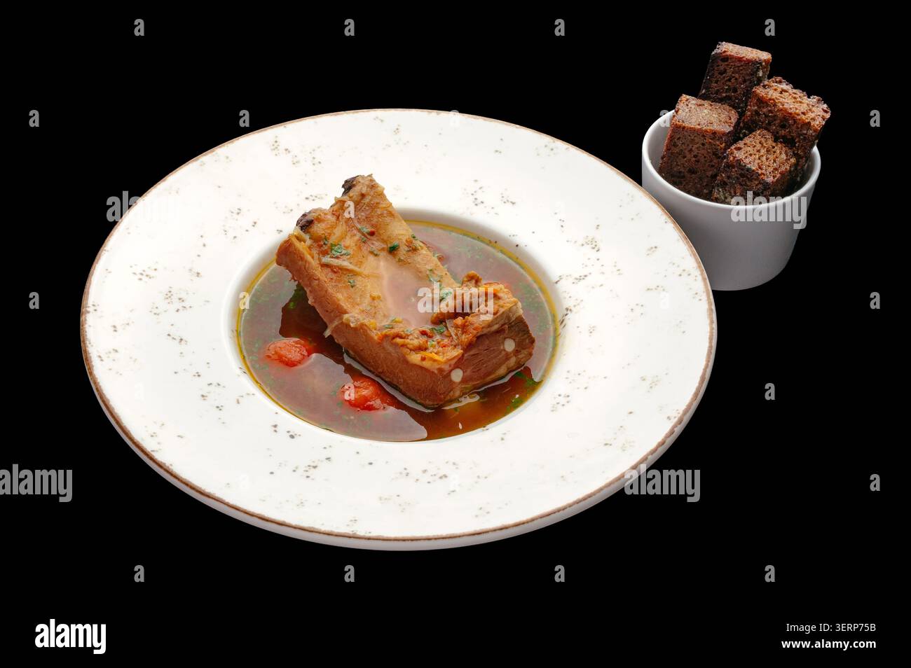 Pork ribs in broth with rye bread croutons Stock Photo