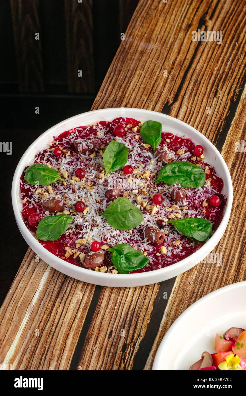 Gourmet beetroot carpaccio salad on a rustic wood table Stock Photo