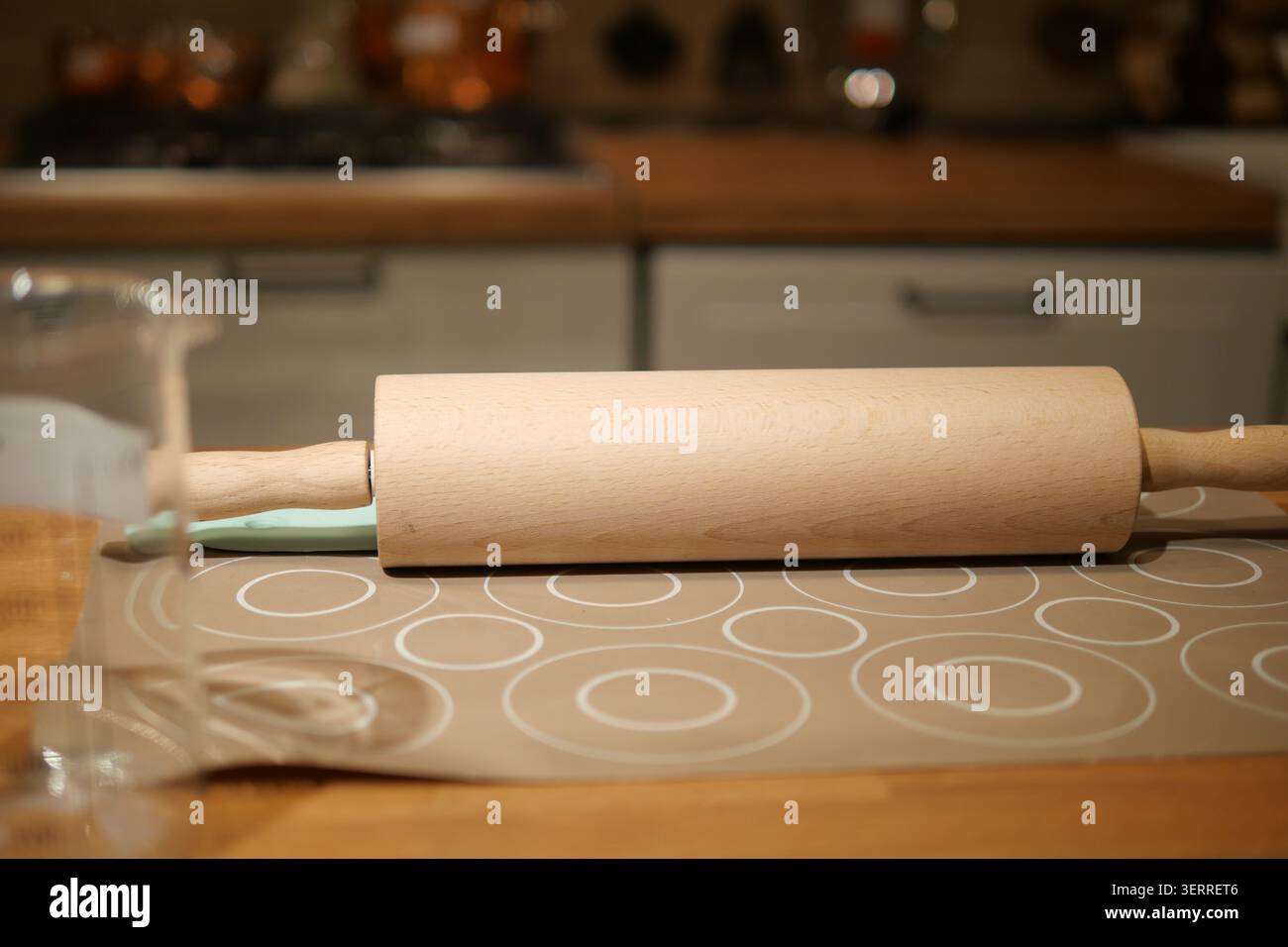 Rolling pin on table in kitchen during cooking time Stock Photo