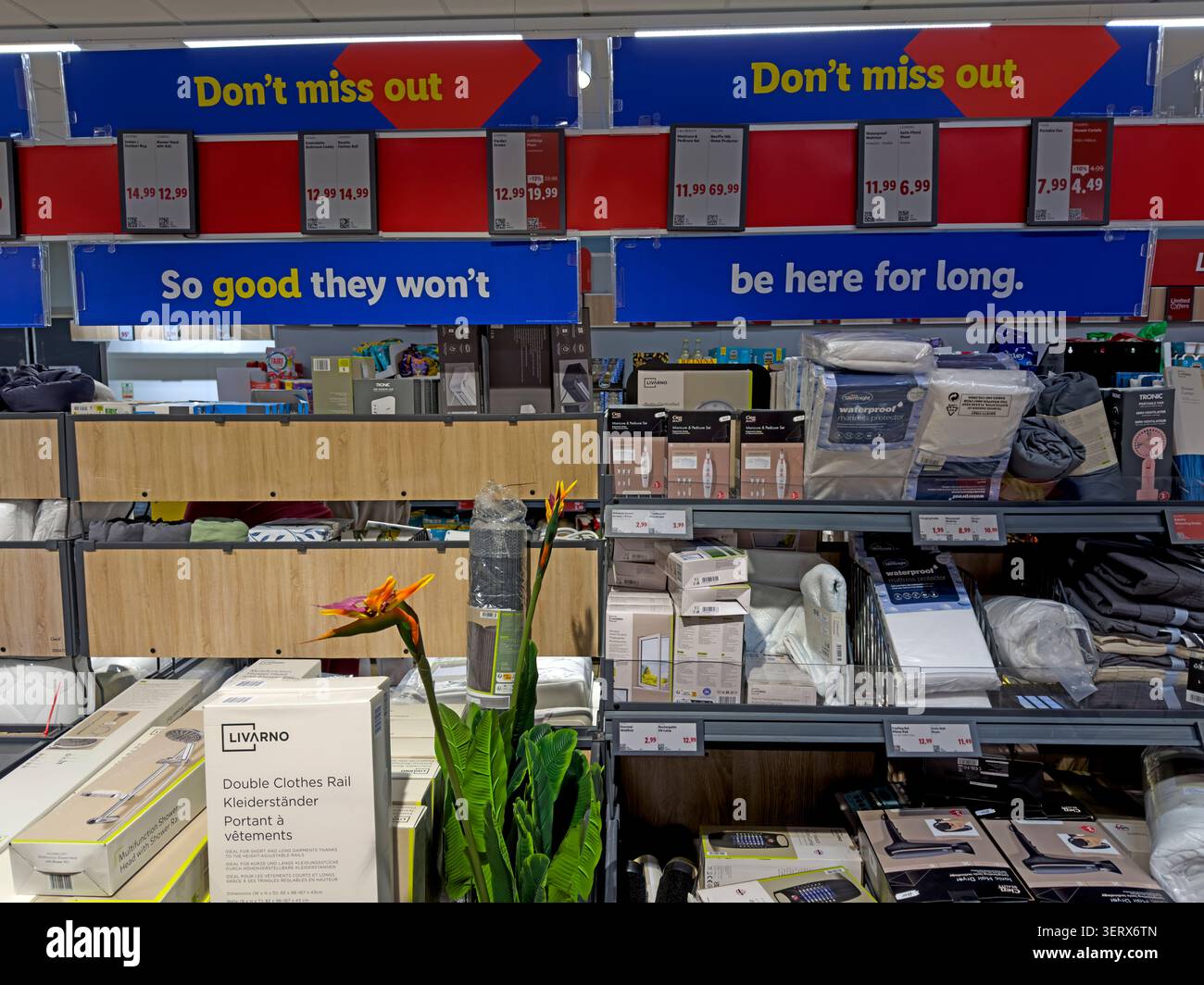 Lidl Middle of Lidl bargain aisle beneath limited-stock signs at Thelwall Lane, Latchford, Warrington, UK, summer 2026 Stock Photo