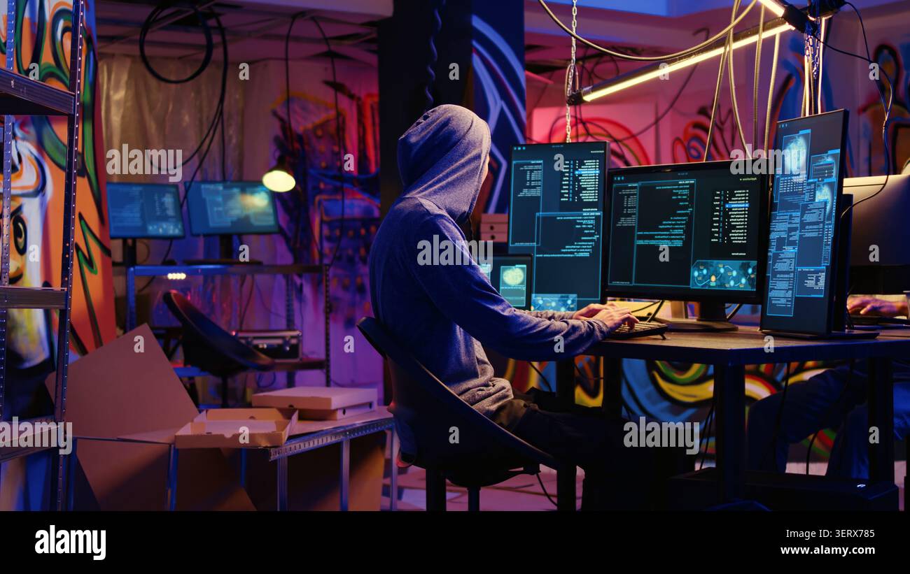 Hackers in secret bunker using phishing technique that tricks users into revealing sensitive information, rogue programmers stealing passwords from low security systems using cyber attacks. Stock Photo
