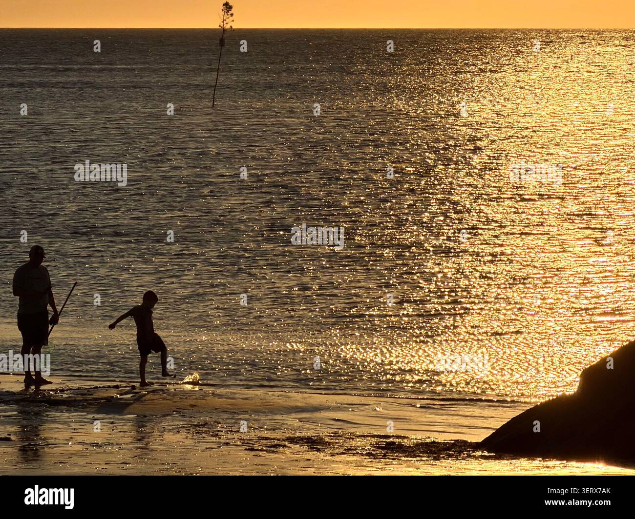 Viewing sunset from a beach and jetty next to Rock Harbor, Orleans, Cape Cod, Massachusetts. - Smartphone Captured Stock Image