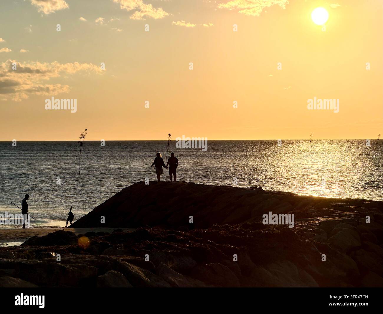 Viewing sunset from a beach and jetty next to Rock Harbor, Orleans, Cape Cod, Massachusetts. - Smartphone Captured Stock Image