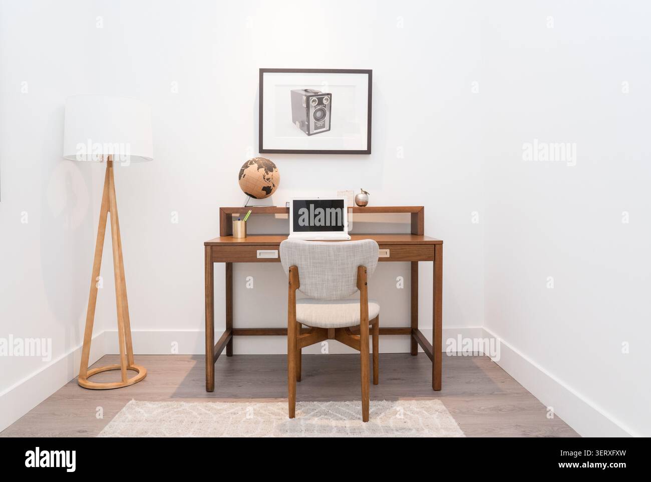Cozy study nook in a modern family home featuring a comfortable workspace, warm decor, and natural light. Stock Photo