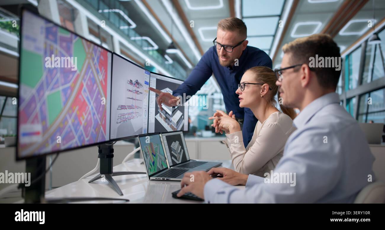 Three Professionals Discuss Local City Planning Using BIM And GIS Software. Stock Photo
