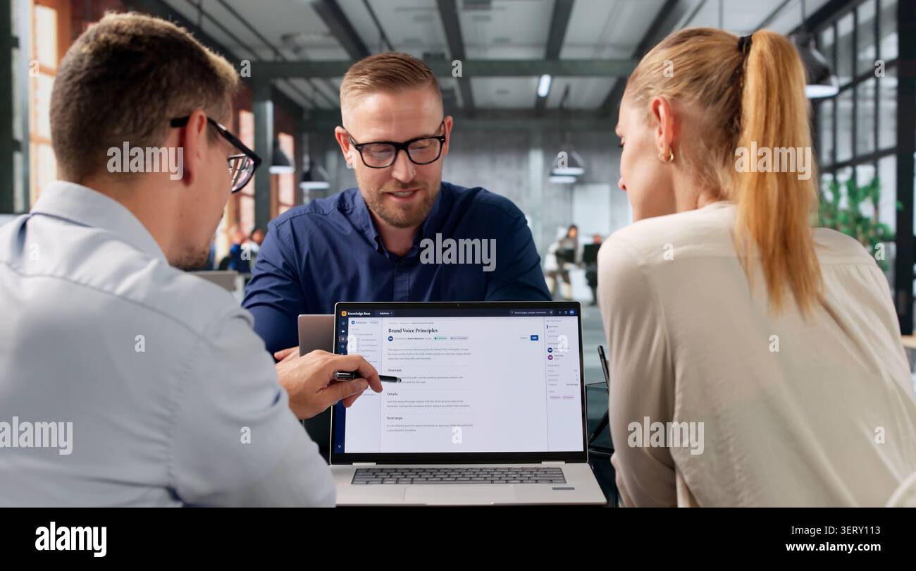 Software Engineer Leads Diverse Team Using AI-powered Knowledge Platform Tools. Stock Photo