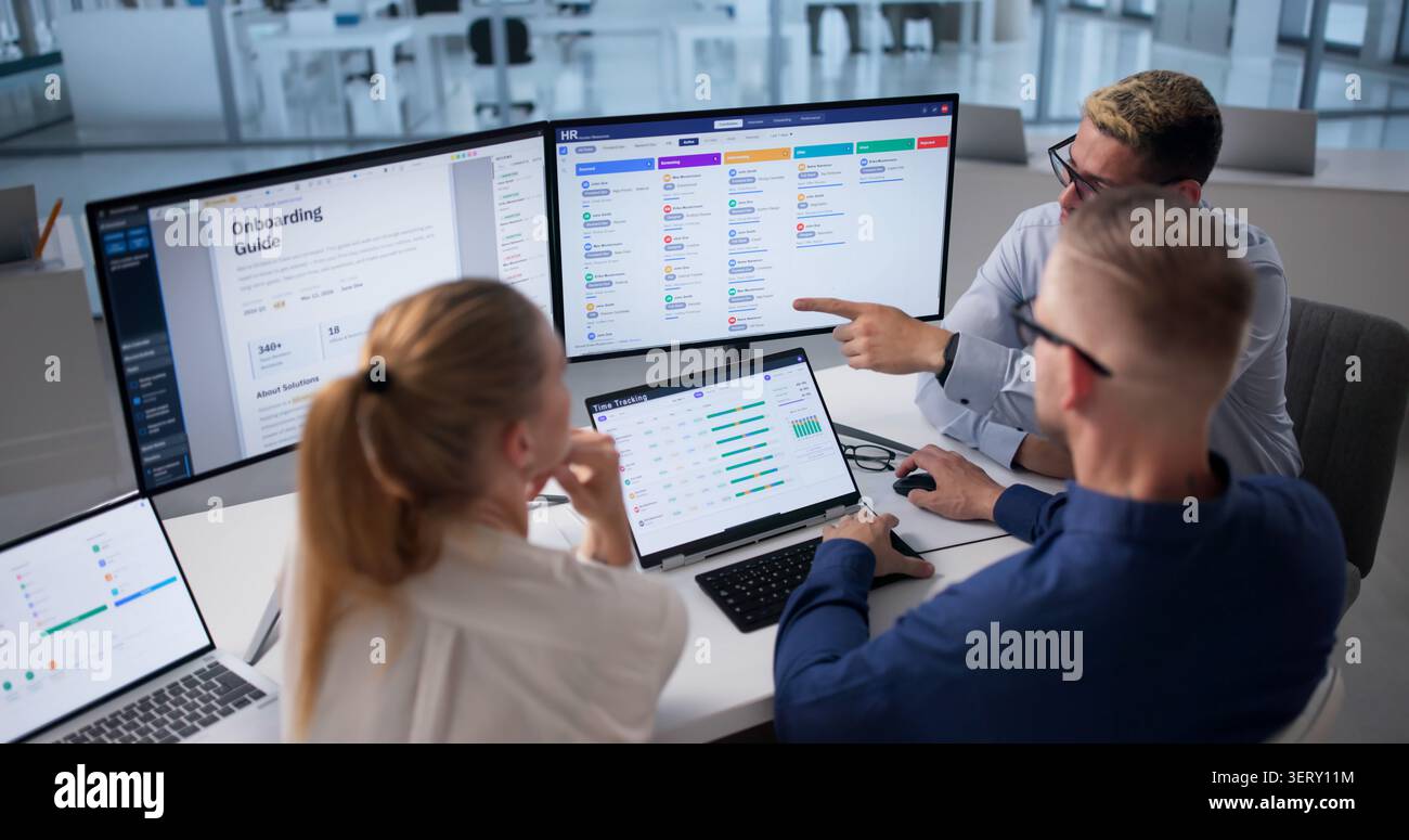 Human Resources Manager Leads Diverse Team Using Software For Recruitment Tasks Stock Photo