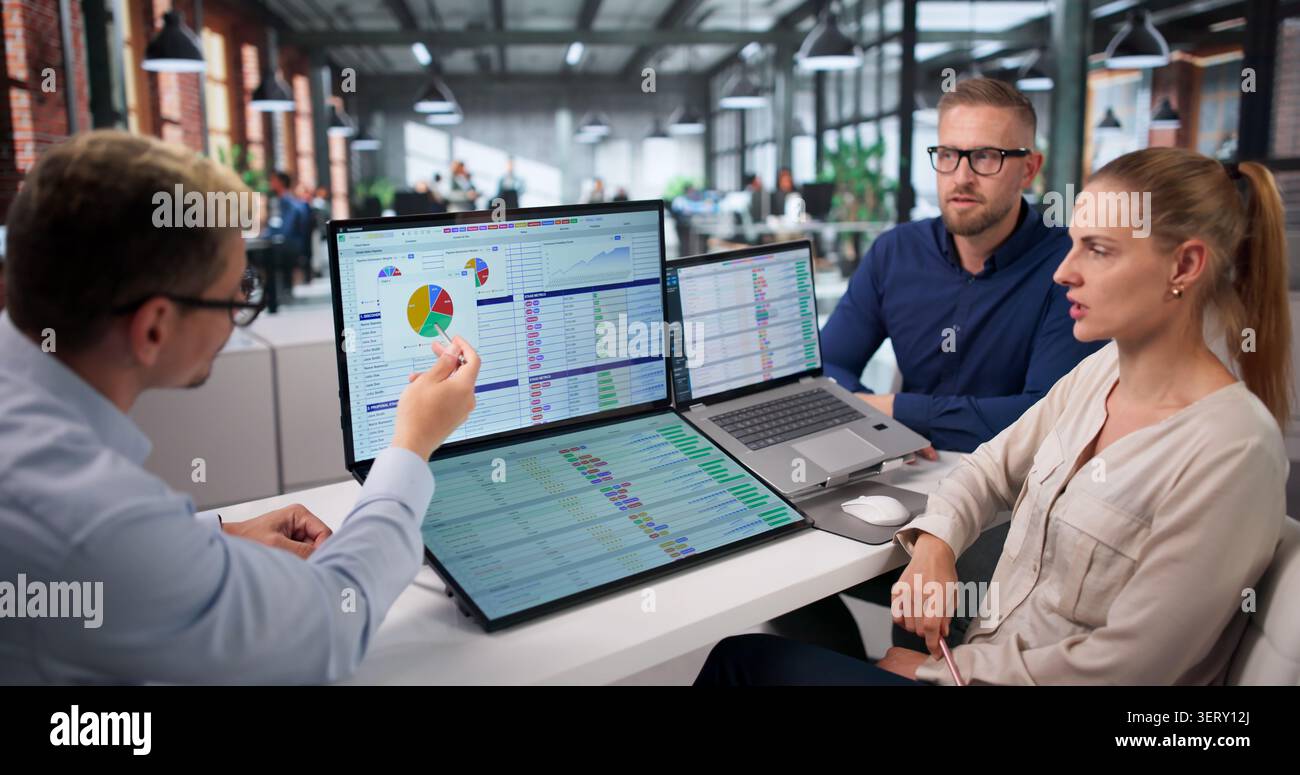 Medical Coder Team Works Together Reviewing Billing Codes On Laptops. Stock Photo