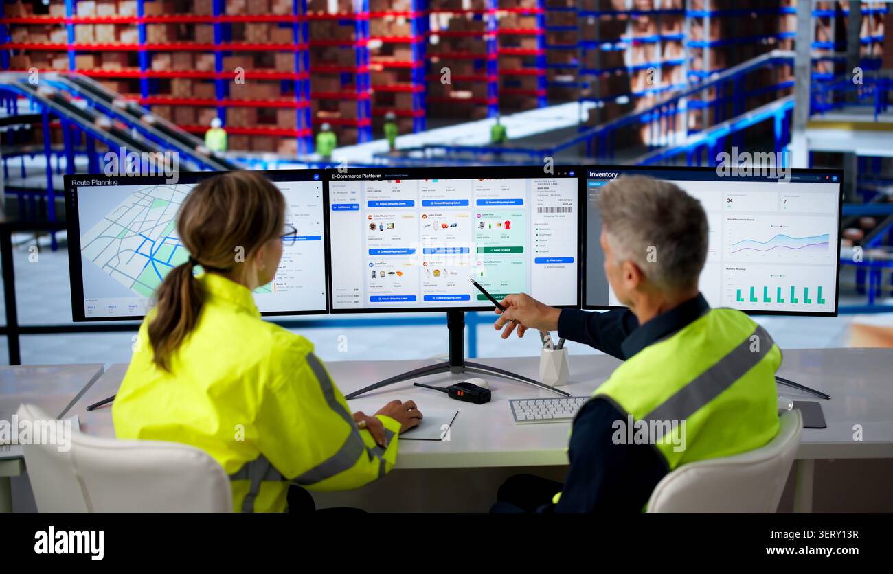 Two Workers Analyze Ecommerce Software On Multiple Screens For Efficient Delivery. Stock Photo